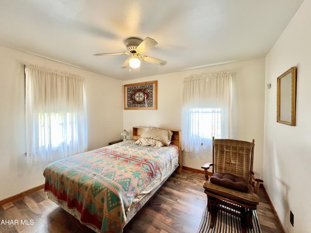 bedroom with ceiling fan and dark hardwood / wood-style flooring