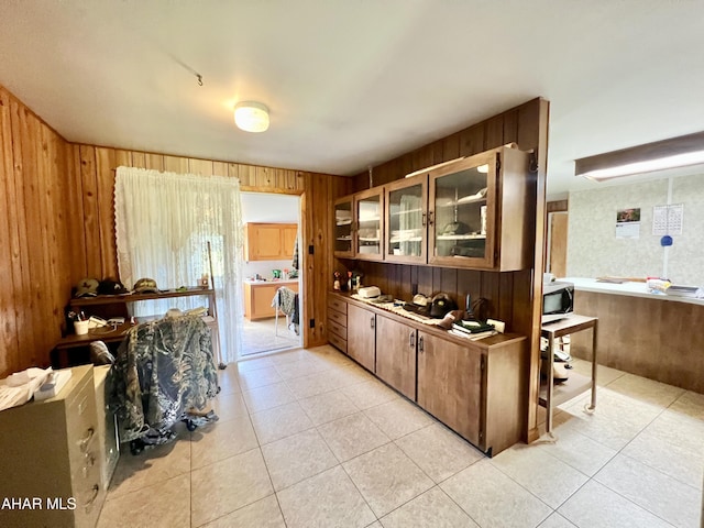 bar with wood walls and light tile patterned flooring