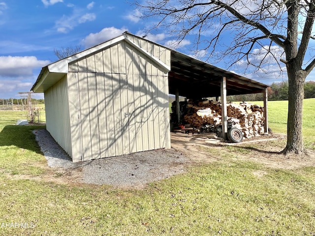 view of outbuilding with a yard