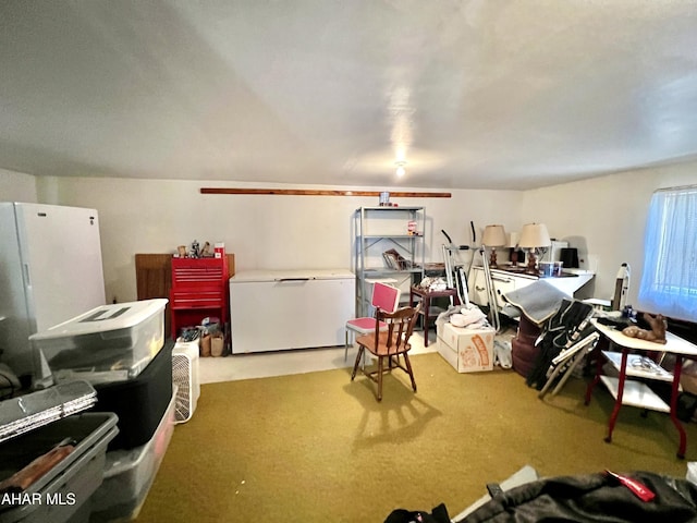 interior space with carpet floors, fridge, and white refrigerator