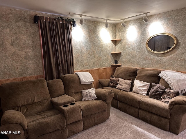 carpeted home theater room featuring track lighting