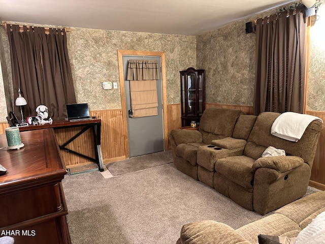 carpeted living room with wooden walls