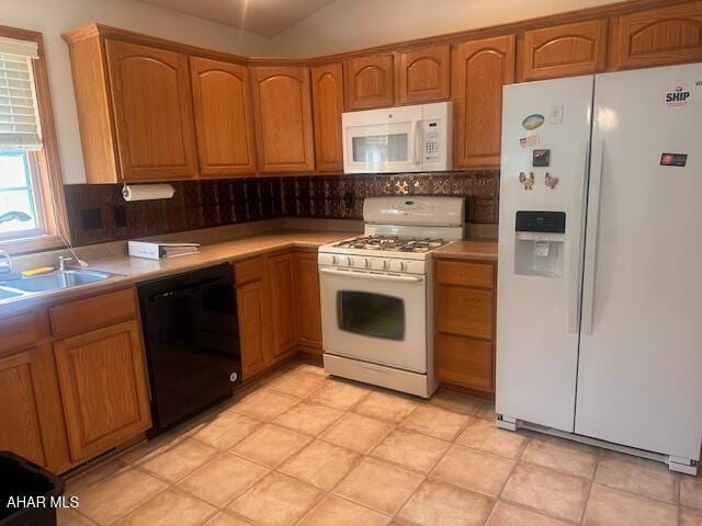 116 Estate Dr, Duncansville, PA 16635 - kitchen with white appliances, backsplash, light countertops, brown cabinets, and vaulted ceiling