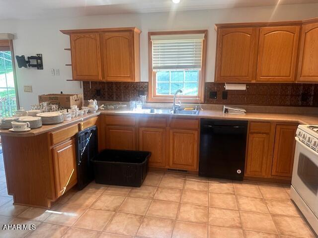 116 Estate Dr, Duncansville, PA 16635 - kitchen with black dishwasher, white stove, a peninsula, and plenty of natural light