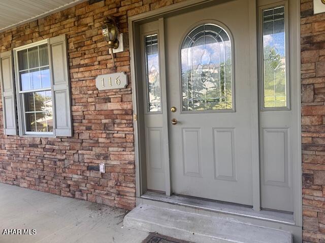 116 Estate Dr, Duncansville, PA 16635 - view of exterior entry featuring covered porch and brick siding