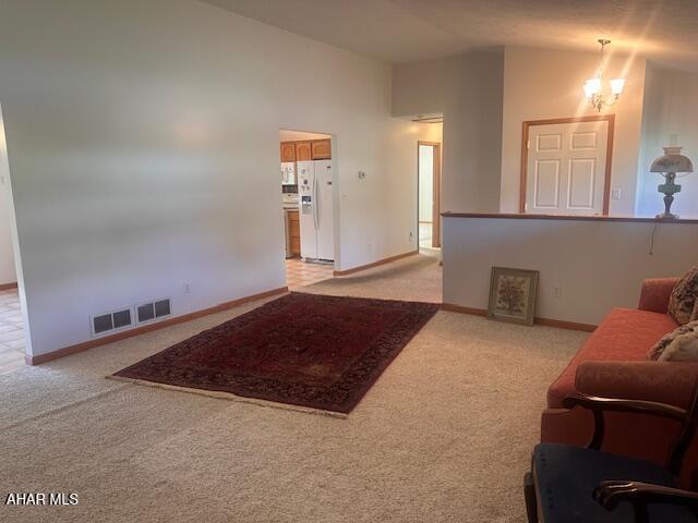 116 Estate Dr, Duncansville, PA 16635 - living area featuring carpet floors, lofted ceiling, and a chandelier