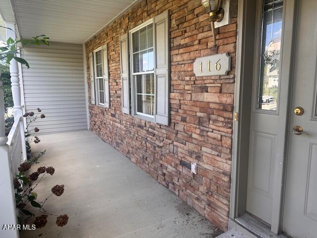 116 Estate Dr, Duncansville, PA 16635 - doorway to property featuring covered porch and brick siding
