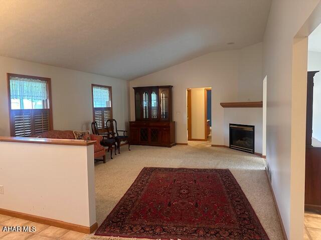 116 Estate Dr, Duncansville, PA 16635 - living room featuring vaulted ceiling, light carpet, and a fireplace