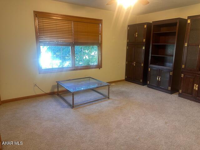 116 Estate Dr, Duncansville, PA 16635 - unfurnished living room featuring light colored carpet and ceiling fan