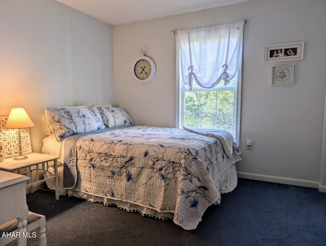 bedroom with dark carpet