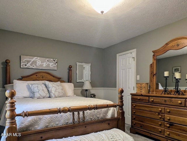 bedroom featuring carpet and a textured ceiling