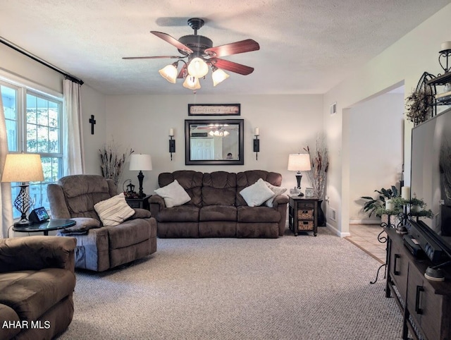 living room with light carpet, a textured ceiling, and ceiling fan