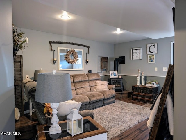 living room with hardwood / wood-style flooring and a wood stove