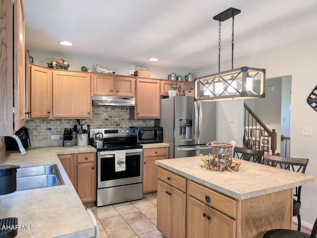 kitchen featuring a center island, a kitchen breakfast bar, pendant lighting, light tile patterned floors, and appliances with stainless steel finishes