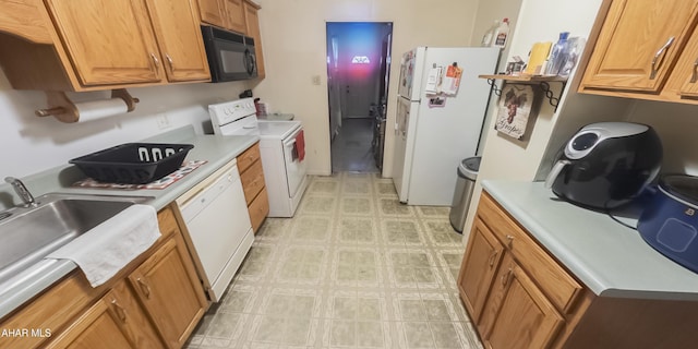 kitchen with washer / dryer, white appliances, and sink