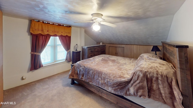 carpeted bedroom featuring vaulted ceiling and a ceiling fan