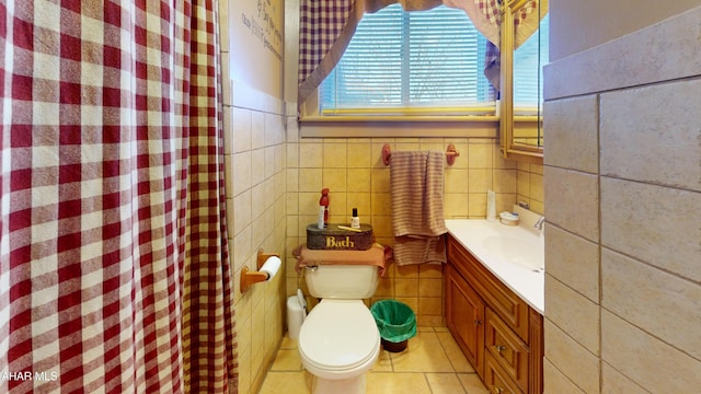 full bath with tile walls, toilet, a shower with curtain, tile patterned floors, and vanity