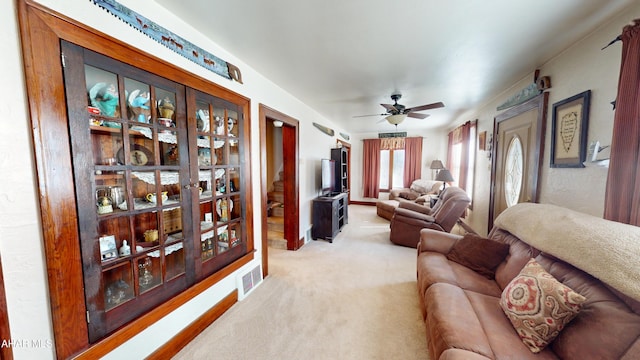 carpeted living room featuring visible vents and ceiling fan