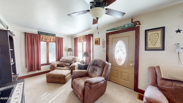 living room with baseboards, light carpet, and ceiling fan