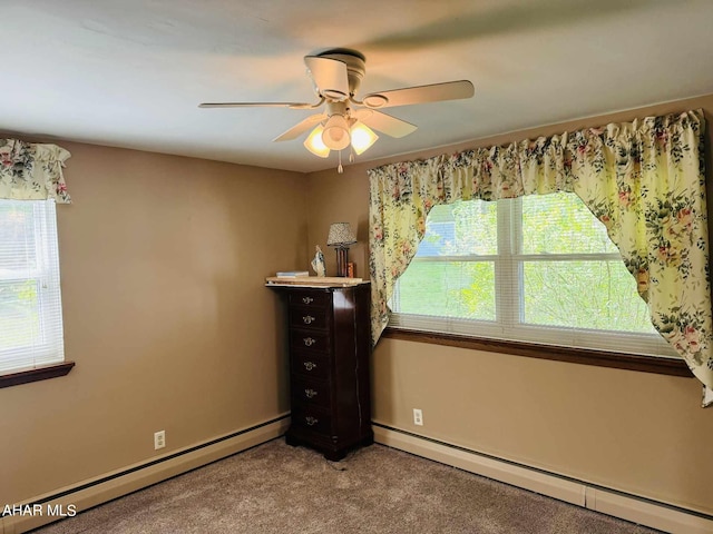 unfurnished bedroom featuring ceiling fan, carpet floors, and a baseboard heating unit