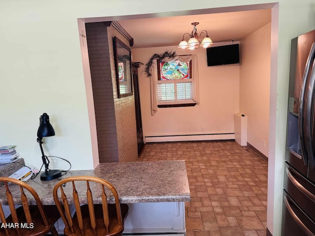 dining room featuring a chandelier and a baseboard heating unit