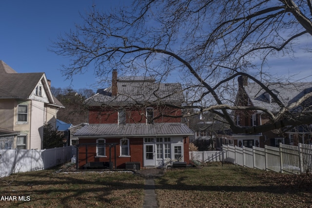 back of property featuring a yard