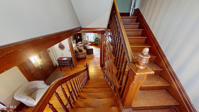 staircase with hardwood / wood-style floors