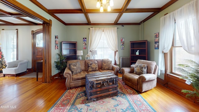 living room with radiator heating unit, coffered ceiling, beamed ceiling, a notable chandelier, and hardwood / wood-style flooring