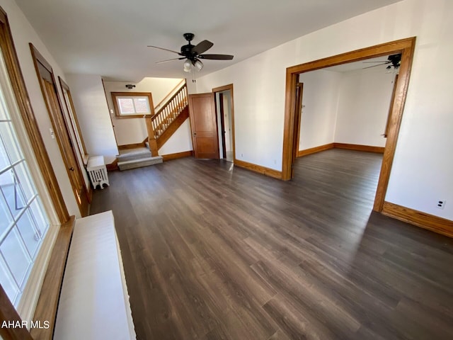 unfurnished living room with ceiling fan and dark hardwood / wood-style flooring