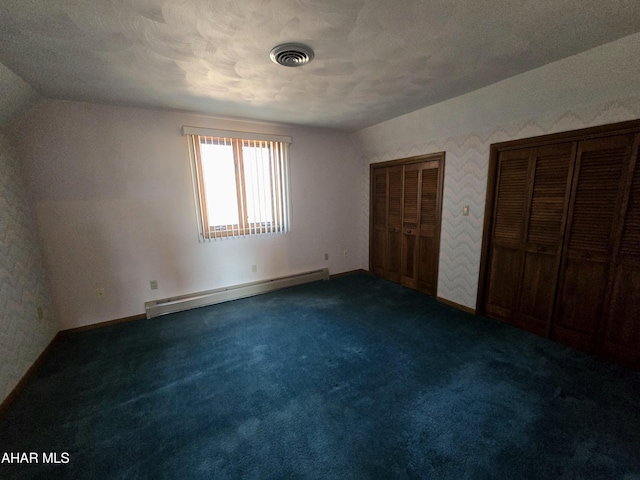 116 Scenic Knoll Dr, Hollidaysburg, PA 16648 - unfurnished bedroom with multiple closets, visible vents, dark carpet, baseboard heating, and lofted ceiling