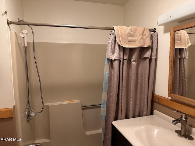 bathroom with shower / bath combination with curtain and vanity