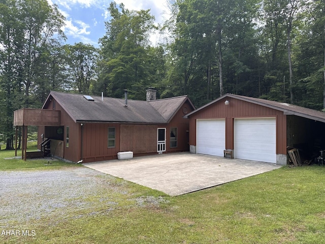 rear view of house with a lawn and a garage