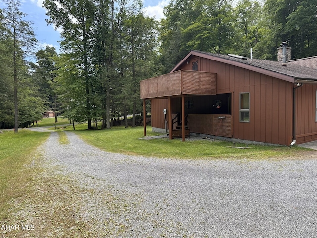 view of outbuilding with a lawn