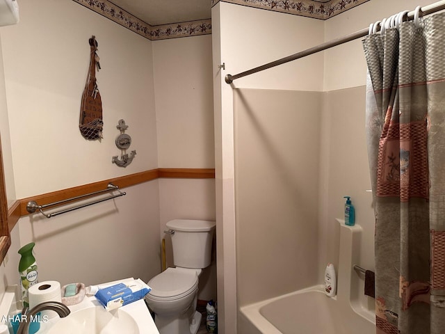 full bathroom with shower / bath combo, toilet, and sink