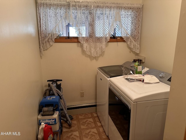 laundry area with washer and dryer and light parquet floors