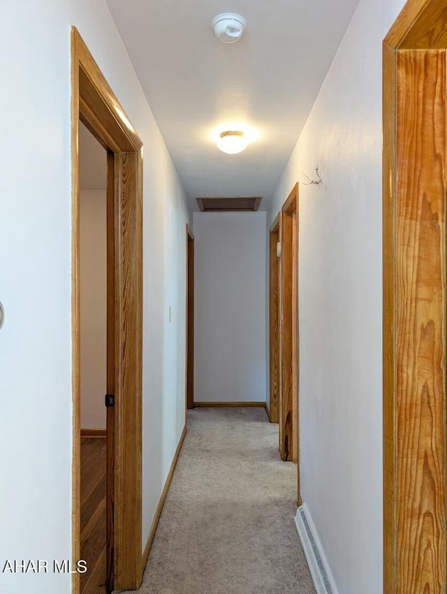 corridor featuring light colored carpet