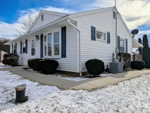 snow covered property with cooling unit