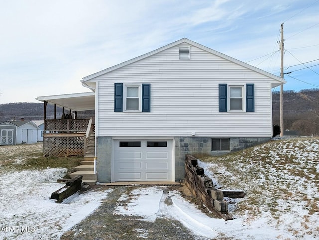 view of snowy exterior with a garage