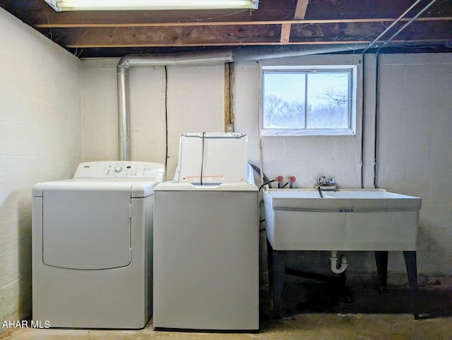 laundry area featuring washer and clothes dryer and sink