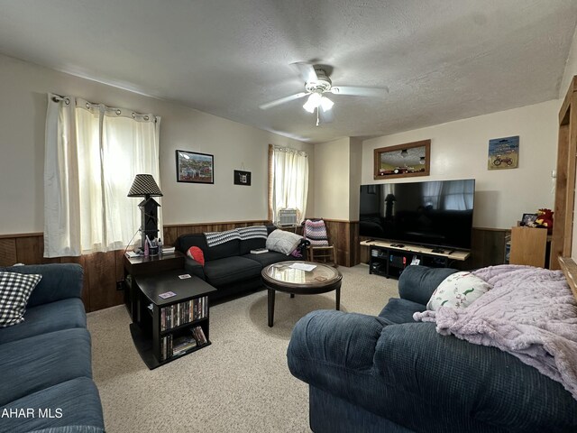 3785 Brumbaugh Rd, New Enterprise, PA 16664 - living area featuring wainscoting, ceiling fan, carpet floors, and wood walls