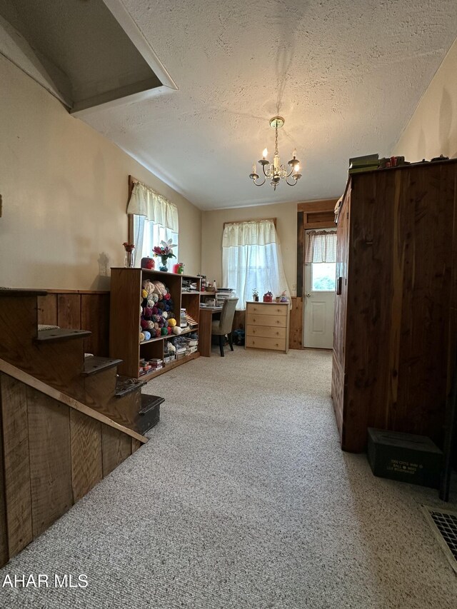 3785 Brumbaugh Rd, New Enterprise, PA 16664 - carpeted home office with a textured ceiling and a chandelier