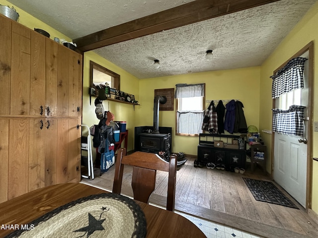 3785 Brumbaugh Rd, New Enterprise, PA 16664 - interior space featuring wood-type flooring, a textured ceiling, and a wood stove