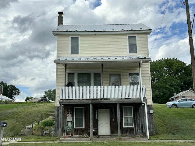 3785 Brumbaugh Rd, New Enterprise, PA 16664 - townhome / multi-family property featuring a front lawn, a metal roof, and a chimney