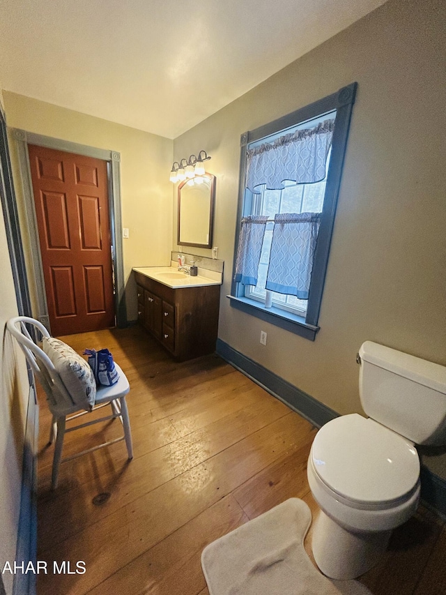 217 Good Shepherd Rd, Altoona, PA 16601 - bathroom with wood-type flooring, toilet, vanity, and baseboards