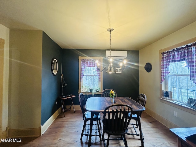 217 Good Shepherd Rd, Altoona, PA 16601 - dining space with wood-type flooring, an AC wall unit, baseboards, and an inviting chandelier
