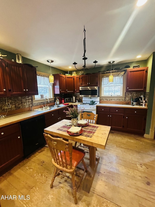 217 Good Shepherd Rd, Altoona, PA 16601 - kitchen with light countertops, stainless steel microwave, decorative light fixtures, decorative backsplash, and black dishwasher
