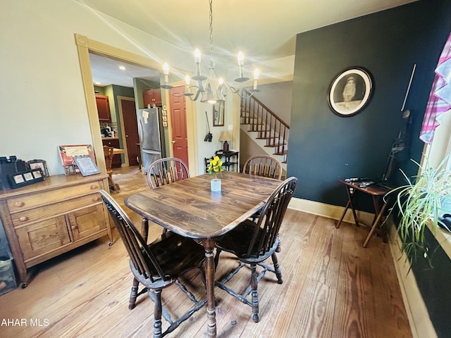 217 Good Shepherd Rd, Altoona, PA 16601 - dining area with baseboards, a chandelier, stairs, and light wood-type flooring