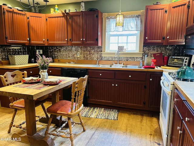 217 Good Shepherd Rd, Altoona, PA 16601 - kitchen featuring light countertops, a sink, white gas stove, a chandelier, and tasteful backsplash