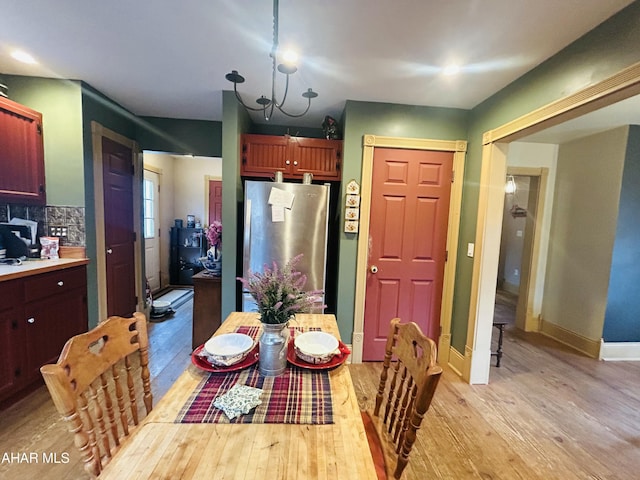 217 Good Shepherd Rd, Altoona, PA 16601 - dining area with baseboards, a notable chandelier, and light wood-type flooring