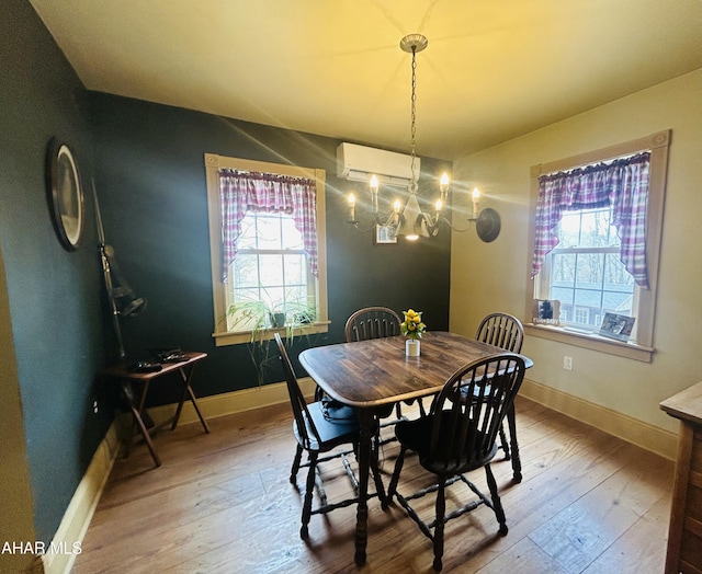 217 Good Shepherd Rd, Altoona, PA 16601 - dining space with baseboards, plenty of natural light, a wall unit AC, and hardwood / wood-style flooring